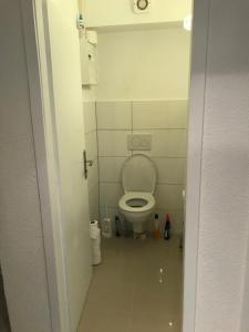 a bathroom with a toilet in a small room at Cozy Room in Ludwigsburg in Ludwigsburg