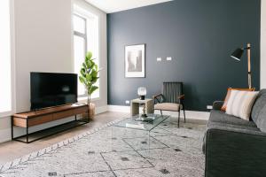 uma sala de estar com um sofá e uma televisão de ecrã plano em Sonder Greektown em Chicago