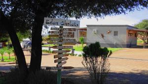 a street sign in front of a building at Eden Chalets in Windhoek