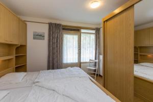 a bedroom with a large bed and a window at Burg. Van Woelderenlaan 100-2 in Vlissingen