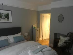 Een bed of bedden in een kamer bij Tranquil, luxurious double bedroom, en-suite, cosy private lounge, woodburner & your own front door