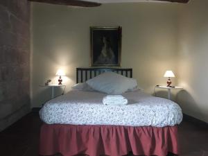 a bedroom with a bed with two lamps on either side at Lo Cremallé in Valderrobres