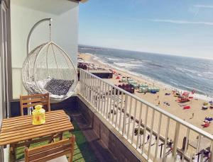 a balcony with a view of a beach at Mar Beach Apartment in Póvoa de Varzim