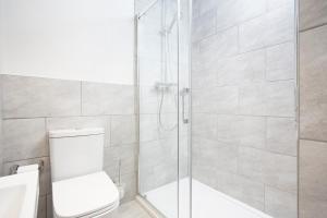 a bathroom with a glass shower with a toilet at Boat House in Whitstable