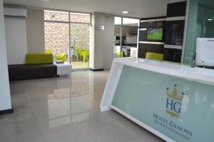 a lobby with a large glass display in a building at Hotel Genova Prado in Barranquilla
