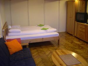 a room with a bed and a couch and a table at 4YOU Citycenter Apartments in Budapest