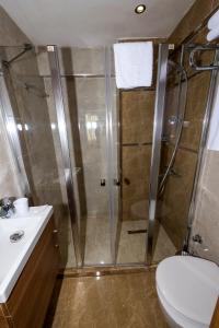 a bathroom with a shower and a toilet and a sink at BGuest Hotel & Residence in Istanbul