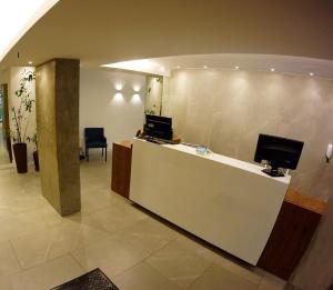 a lobby with a reception desk with a computer on it at Solar Flat Hotel in Juiz de Fora