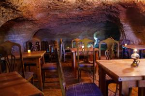 restauracja ze stołami i krzesłami w jaskini w obiekcie Finca Patio Canario w Aronie