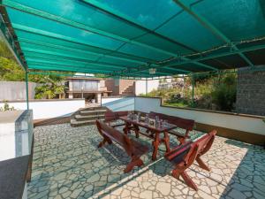 a patio with a table and chairs and a blue canopy at Apartments Adria in Dramalj