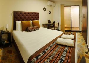 Voodi või voodid majutusasutuse Hotel Alamos Del Parque toas