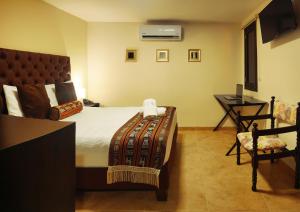 Voodi või voodid majutusasutuse Hotel Alamos Del Parque toas