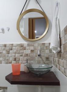 a bathroom with a glass sink and a mirror at Suíte da Vila - Beira Mar in Abraão +45 photos