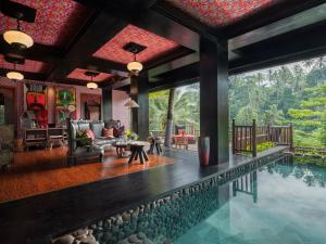 a villa with a swimming pool and a living room at Capella Ubud, Bali in Ubud