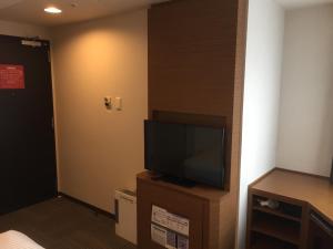a television is on in a small room at HOTEL MYSTAYS Kamata in Tokyo