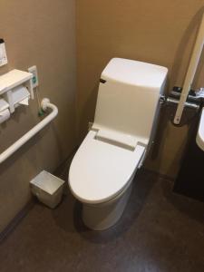 a bathroom with a white toilet in a stall at HOTEL MYSTAYS Kamata in Tokyo