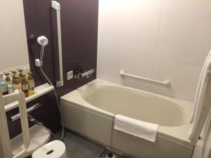 a bathroom with a bath tub and a toilet at HOTEL MYSTAYS Kamata in Tokyo