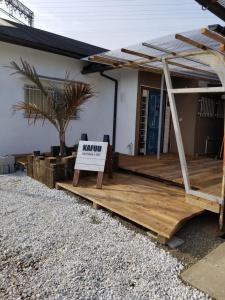 a house with a sign on a wooden deck at KAFUU guesthouse+cafe in Kashiba +9 photos
