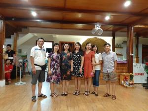 a group of people posing for a picture in a dance floor at Mai Chau Dreams Homestay in Mai Châu