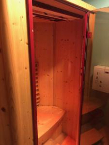 a wooden cabinet with a bench in a room at Ivorytowers Accommodation in Fox Glacier