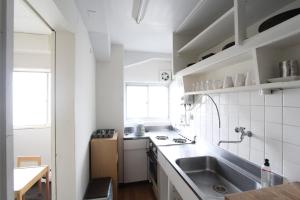 a white kitchen with a sink and a counter at Sea View Court Kobe in Kobe +273 photos
