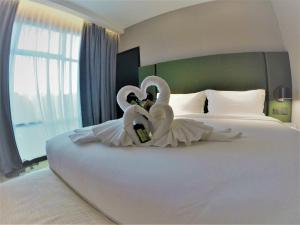 Postel nebo postele na pokoji v ubytování King Park Hotel Kota Kinabalu