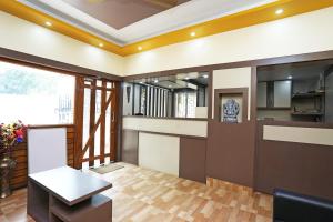Il comprend un salon avec une table et une cuisine. dans l'établissement Kristi Guest House, Shantiniketan, à Santiniketan