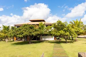 a house with trees in front of it at Casa Corveta in São Miguel do Gostoso