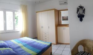 a bedroom with a bed and a cabinet at Casa Svjetlana in Orebić