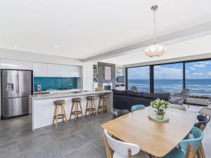 a kitchen and living room with a table and chairs at Aqua Mist in Port Fairy