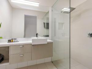 a bathroom with a sink and a shower at Chimneys On Bank in Port Fairy