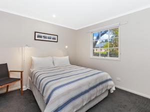 
A bed or beds in a room at Corella Cottage
