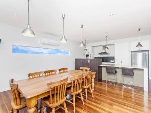 a kitchen and dining room with a wooden table and chairs at Escape 2 Brophy in Port Fairy