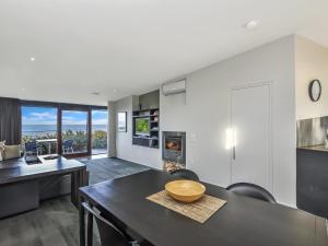 a kitchen and dining room with a table and chairs at Hearns Beachside Villa 1 in Port Fairy
