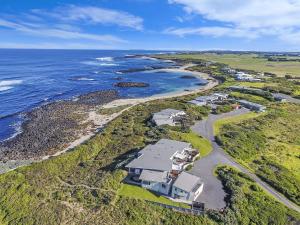 an aerial view of a house next to the ocean at Hearns Beachside Villa 1 in Port Fairy