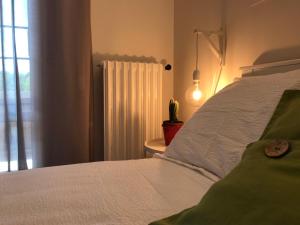 a bedroom with a white bed and a window at Pisacane61 B&B in Modena