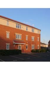 a large red brick building with a street in front of it at Appleby Darlington in Darlington