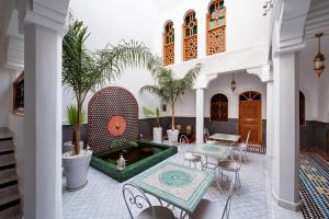 a courtyard with a fountain in the middle of a building at Emma's Riad in Marrakech
