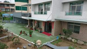 a house with a fake yard in front of it at Smile house Homestay in Taiping