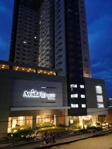 a building with an akitaavascript sign in front of two tall buildings at Patrick s Place in Davao City