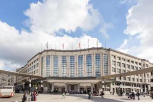 a large building with flags on top of it at Super Flat Next Grand Place in Brussels