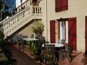 two tables and chairs sitting outside of a building at Hotel Alameda in Zarautz