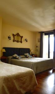 a bedroom with two beds and a mirror on the wall at Hotel Alameda in Zarautz