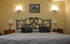 a bedroom with a large bed with two pillows at Hotel Alameda in Zarautz