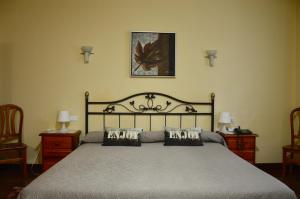a bedroom with a large bed with two night stands at Hotel Alameda in Zarautz