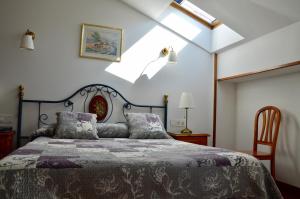 a bedroom with a bed and a skylight at Hotel Alameda in Zarautz