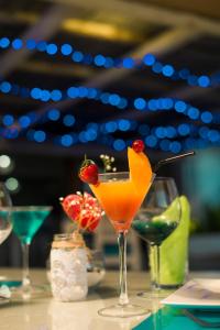 a drink with a strawberry on top of a table at Stella Rina in Grand Baie