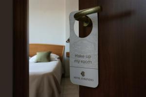a door with a sign that says make up my room at Evripides Hotel in Athens