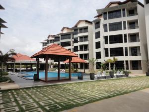 a hotel with a gazebo in front of a building at Samsuria Beach Resort Penthouse in Cherating