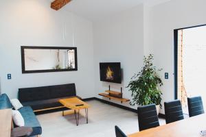 a living room with a couch and a fireplace at Maison jardin pétanque, MEETT, Airbus, aéroport, golf in Beauzelle